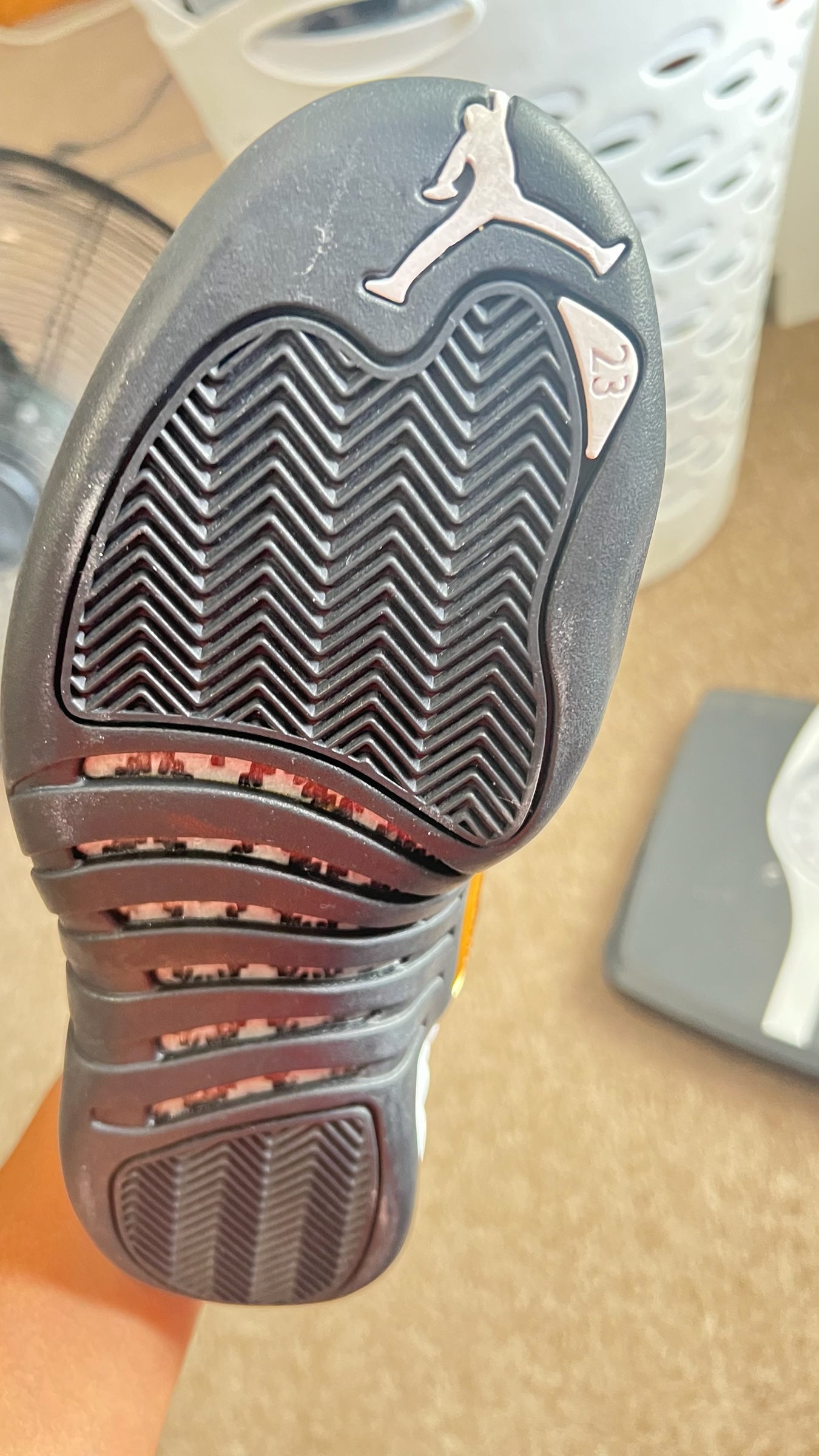 Shop Nova Finds Air Jordan 12 Retro sneaker outsole with black herringbone traction pattern and Jumpman logo