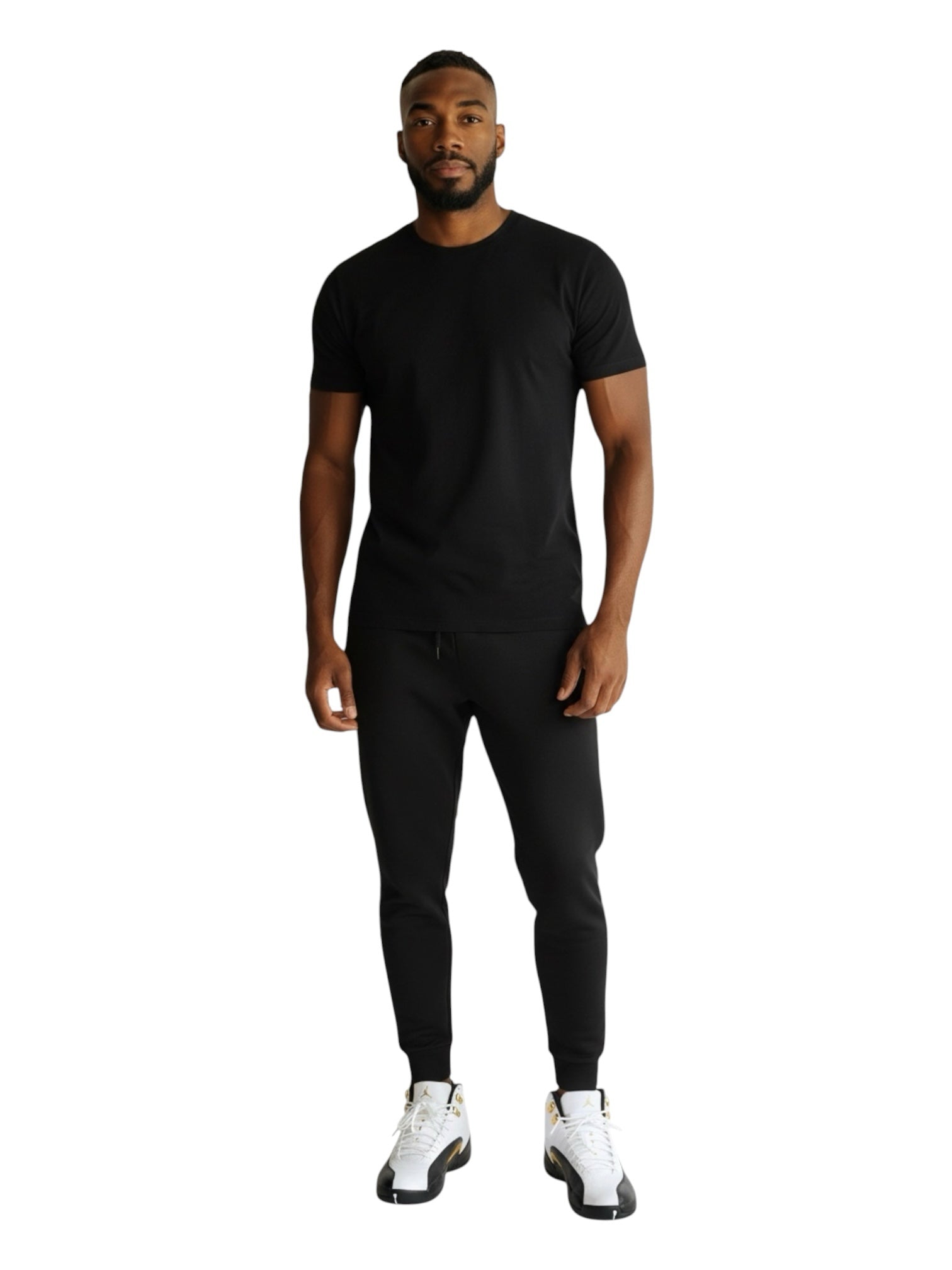 Shop Nova Finds model wearing a black t-shirt and joggers with white and black Air Jordan 12 Retro basketball sneakers