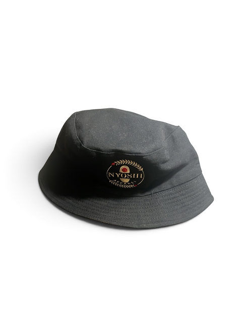 Shop Nova Finds reversible bucket hat in black with a circular embroidered logo patch on the front