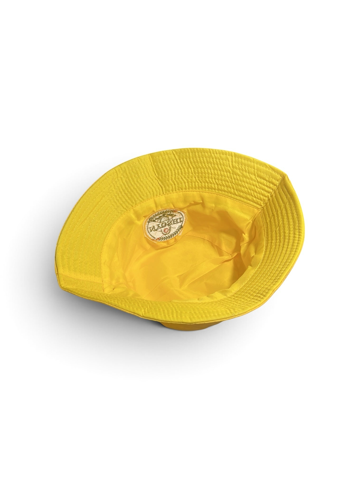 Shop Nova Finds reversible bucket hat in vibrant yellow featuring a circular embroidered Nyoshi Apparel logo patch.